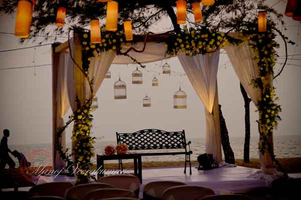 beach wedding decor with hanging cages 